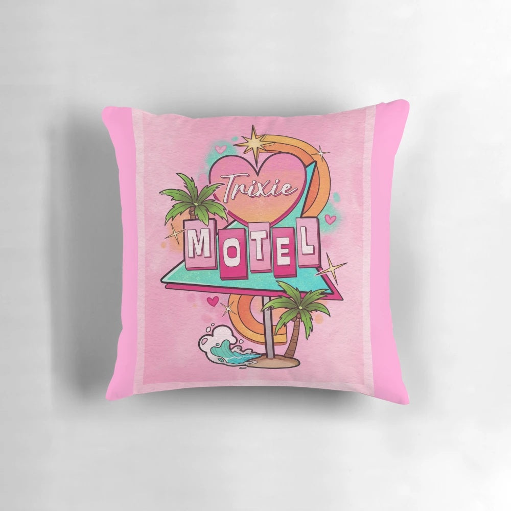 A decorative throw pillow featuring a 1960s-style motel sign with the text "Trixie Motel" in a pink and white color scheme.