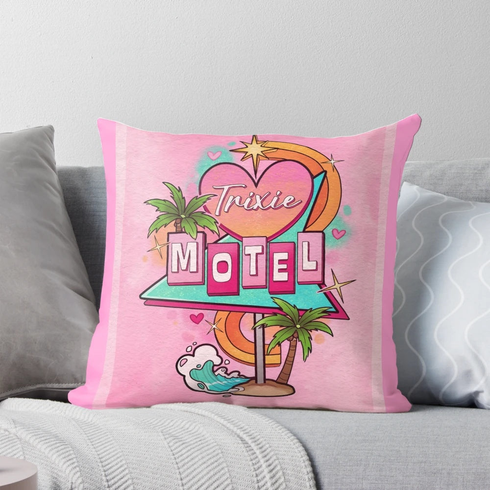 A decorative throw pillow featuring a 1960s-style motel sign with the text "Trixie Motel" in a pink and white color scheme.