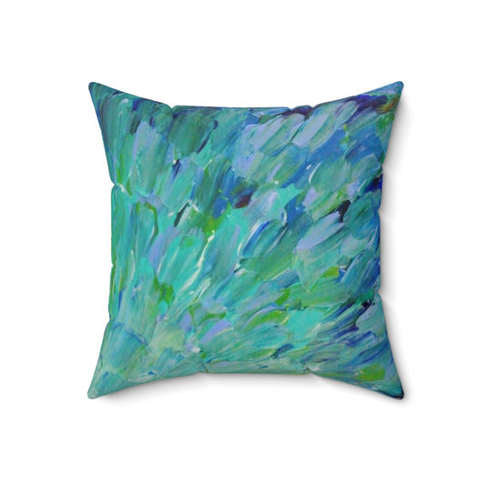 Decorative pillow featuring an abstract design with peacock feathers, mermaid fins, and ocean waves in shades of teal, navy, and avocado green.