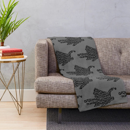Plush blanket featuring 1980s movie characters and references