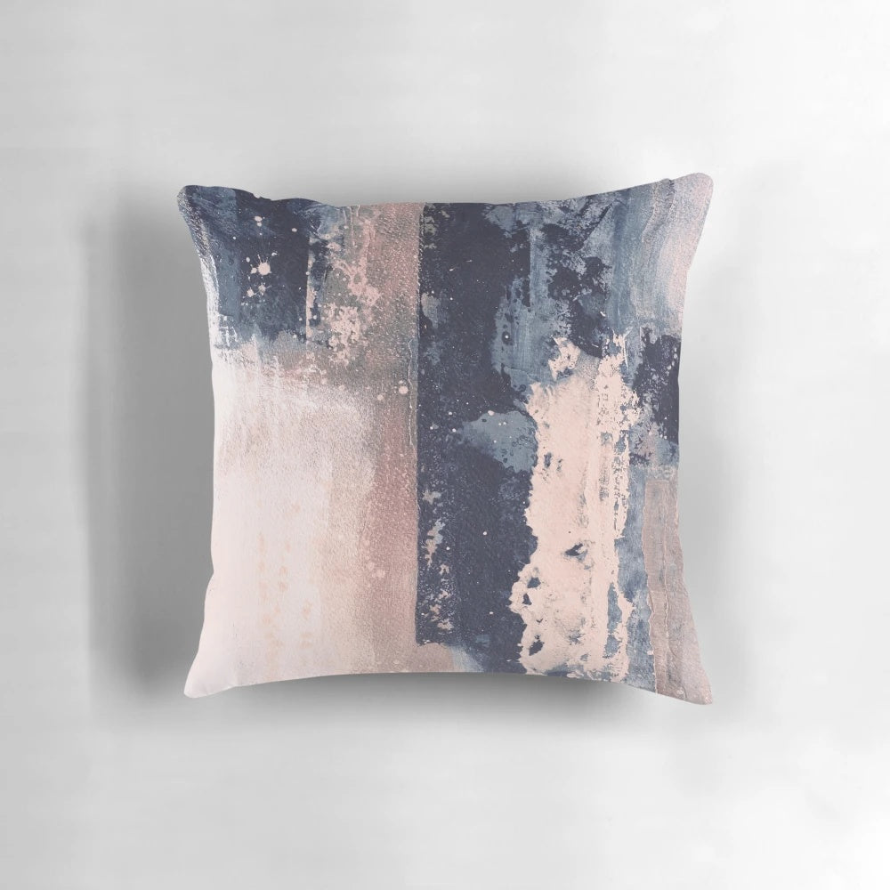 Horizontal abstract art pillow in shades of blush pink and navy blue, featuring brushstrokes and a modern, industrial-style design.