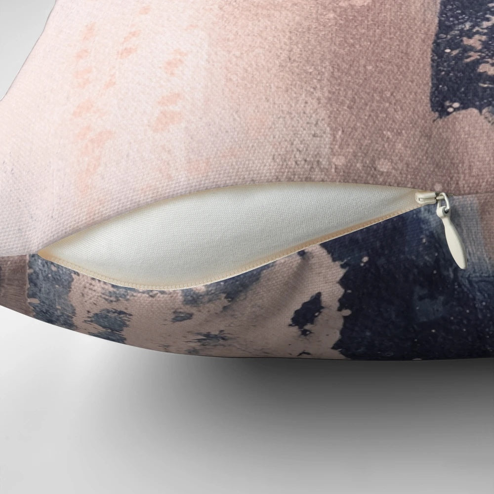Horizontal abstract art pillow in shades of blush pink and navy blue, featuring brushstrokes and a modern, industrial-style design.