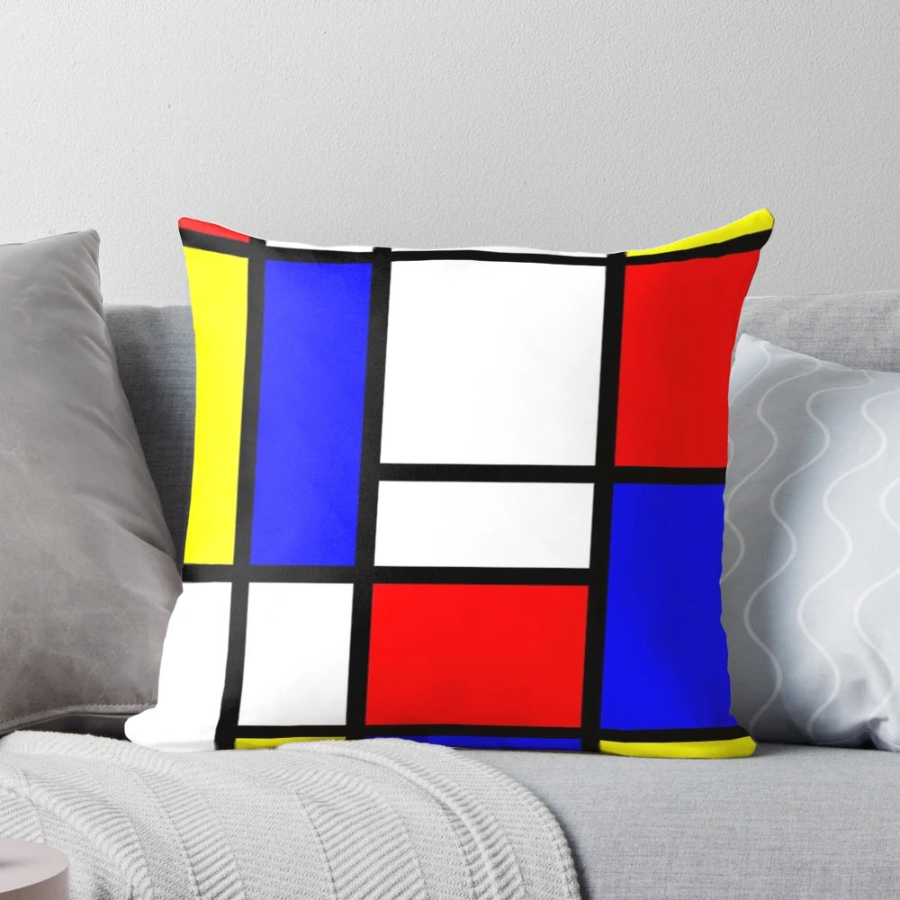 Vibrant abstract art pillow featuring bold geometric shapes and primary colors, inspired by the work of renowned artist Piet Mondrian.