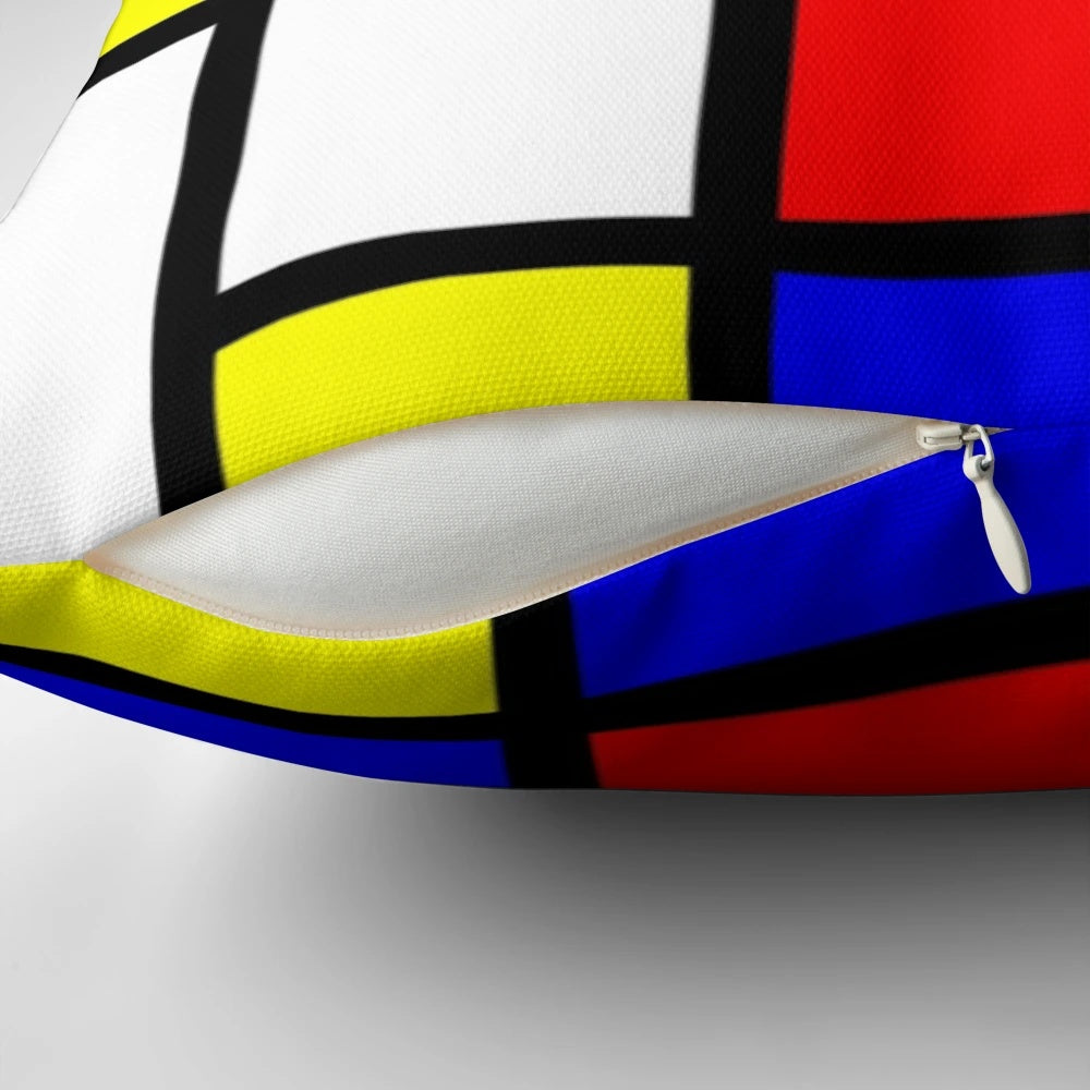 Vibrant abstract art pillow featuring bold geometric shapes and primary colors, inspired by the work of renowned artist Piet Mondrian.