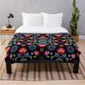 Fiesta folk inspired black plush blanket with abstract floral pattern