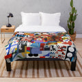 Soft, plush blanket with abstract geometric design inspired by the work of Swiss artist Sophie Taeuber-Arp