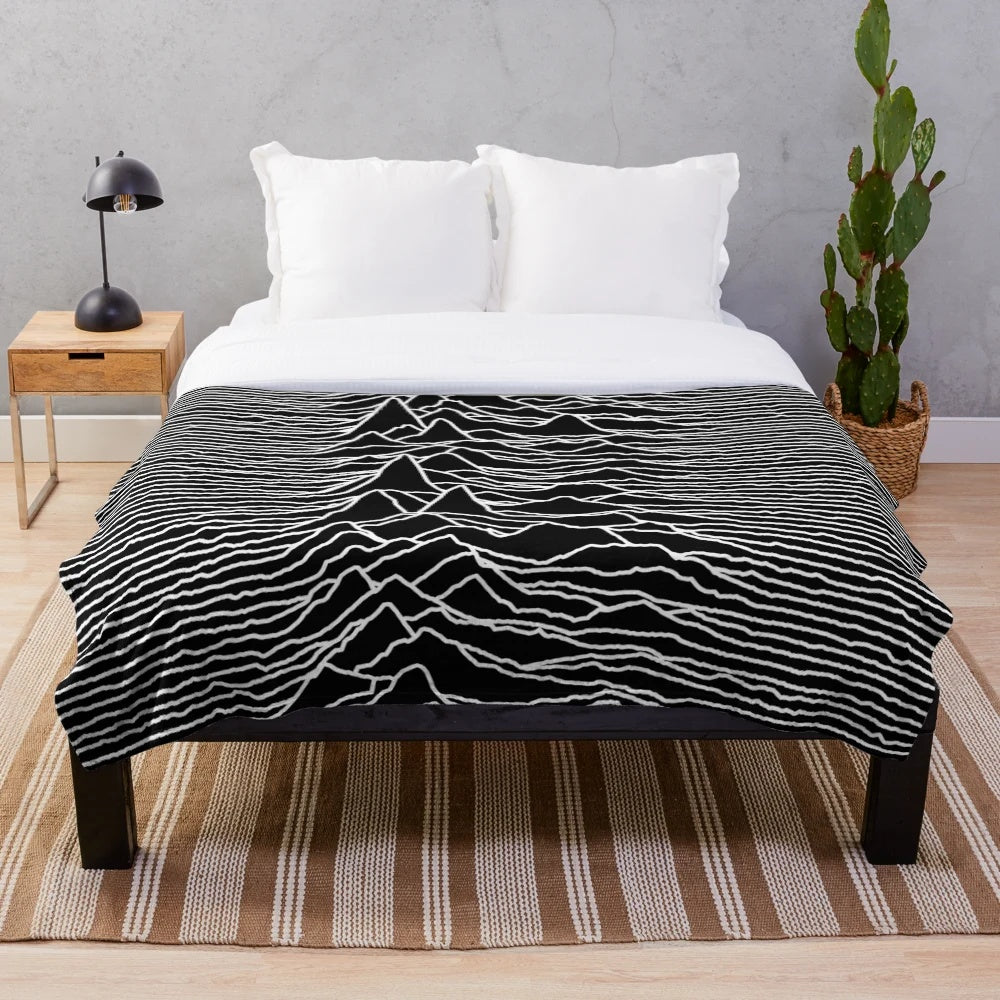 Plush blanket featuring the iconic abstract album art design of the Unknown Pleasures album