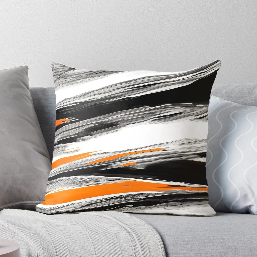 An abstract, circular pattern decorative pillow in shades of orange, gray, and black with paint brush strokes.