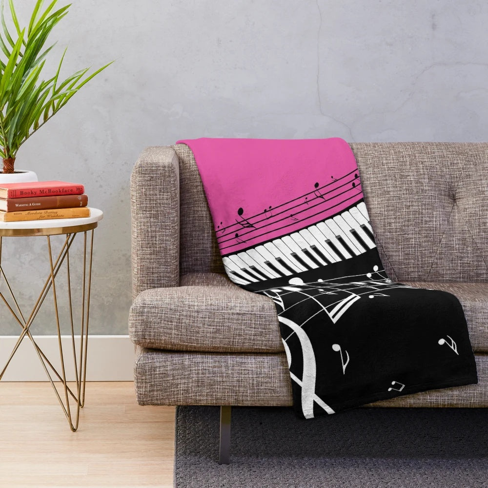 Plush blanket featuring an abstract design of a piano keyboard with musical notes