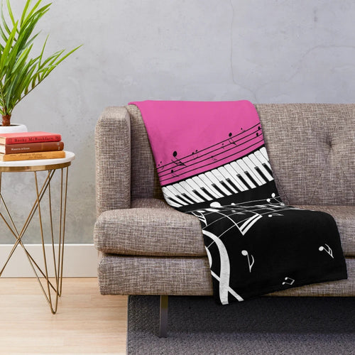 Plush blanket featuring an abstract design of a piano keyboard with musical notes