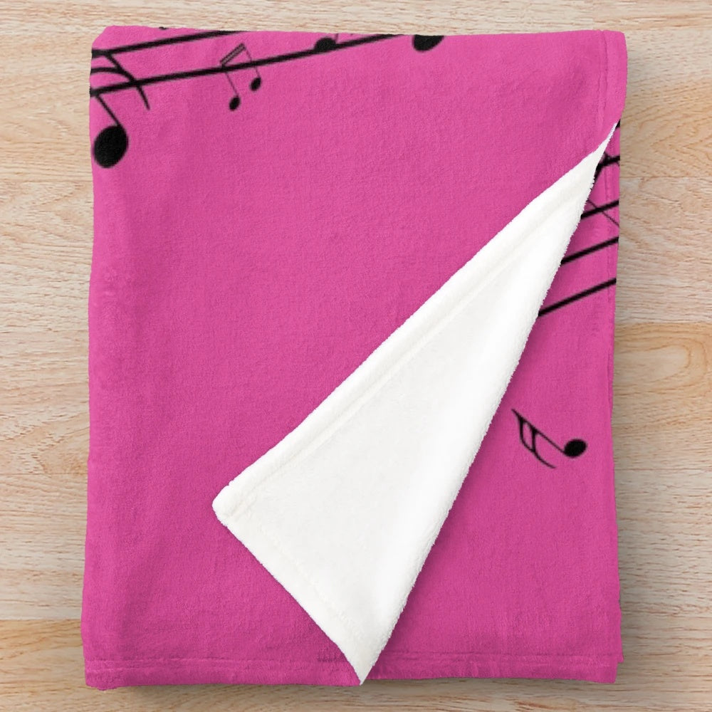 Plush blanket featuring an abstract design of a piano keyboard with musical notes