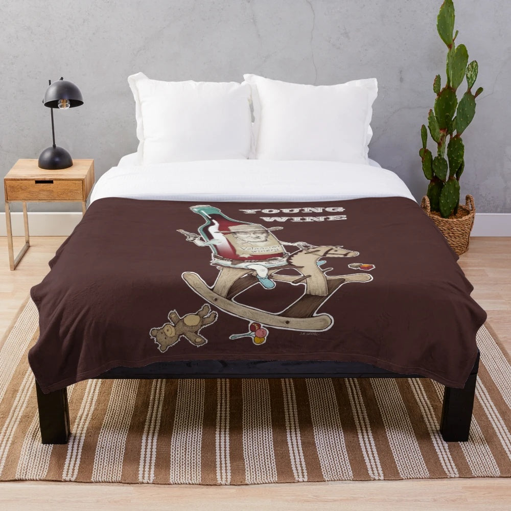 Plush blanket featuring an absurdist design inspired by young wine and cowboy cinema
