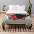 Accordion-themed plush blanket with musical instrument imagery