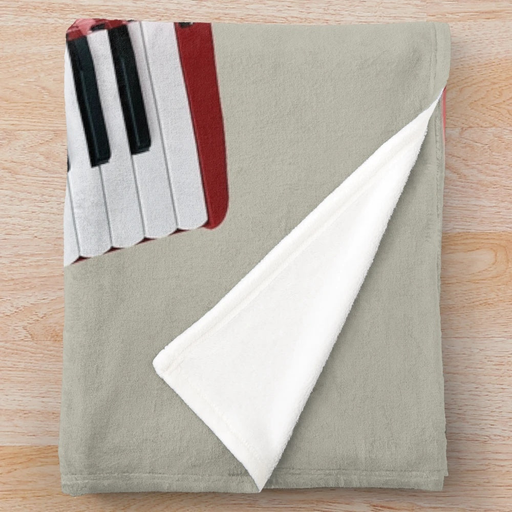 Accordion-themed plush blanket with musical instrument imagery