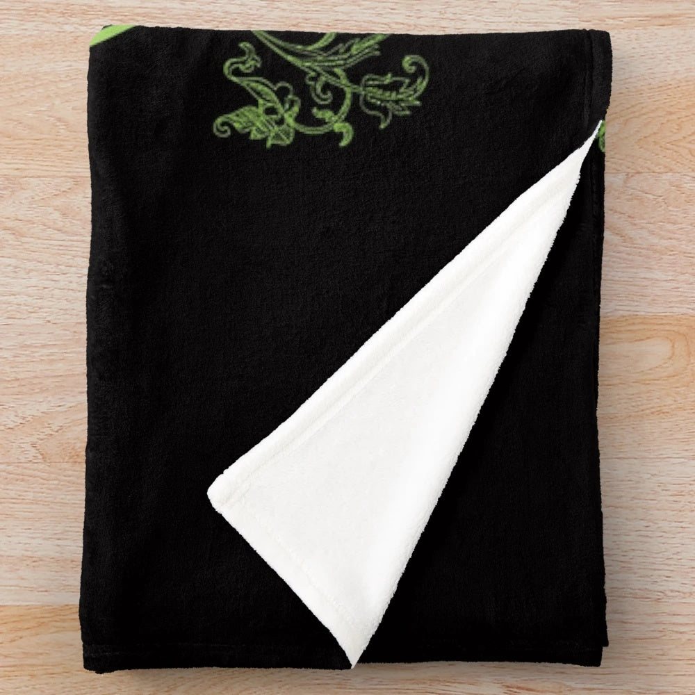 Addams Family inspired plush blanket featuring the iconic "Sic Gorgiamus Allos Subjectatos Nunc" quote
