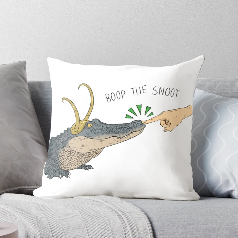 Cozy decorative pillow featuring an alligator character from the Loki series, with the text "Boop the Snoot"