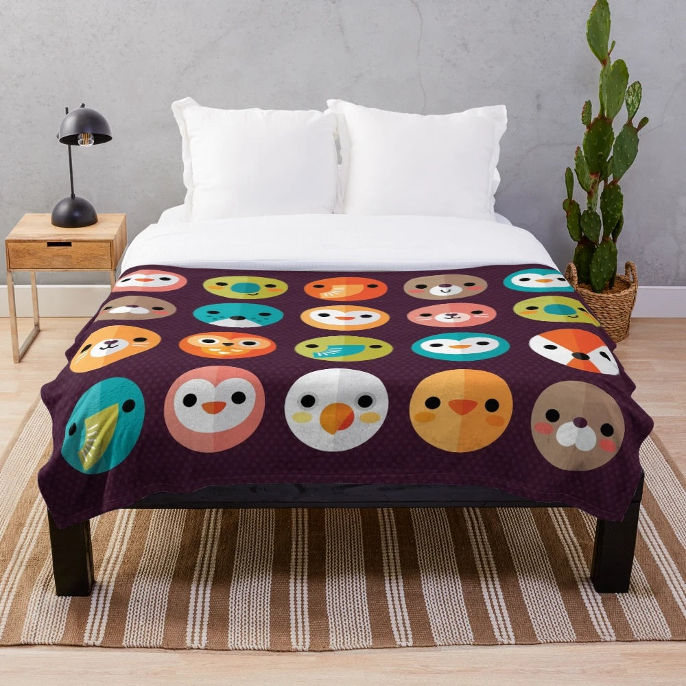 Smiley faces and cute animal designs on a soft, plush blanket