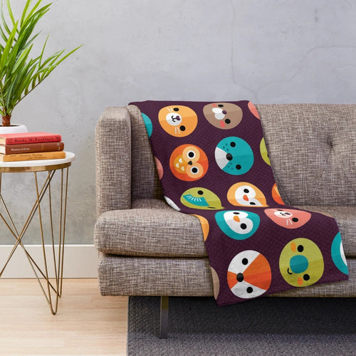 Smiley faces and cute animal designs on a soft, plush blanket