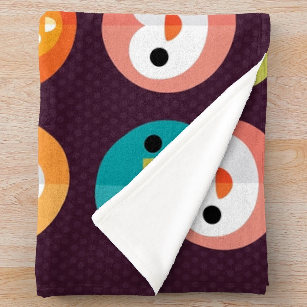 Smiley faces and cute animal designs on a soft, plush blanket