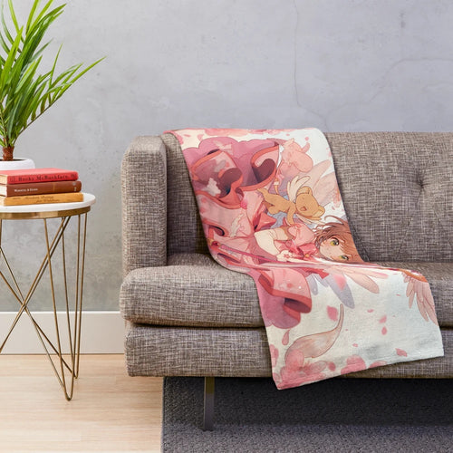Soft, pink plush blanket featuring the characters Sakura and Kero from the popular anime series