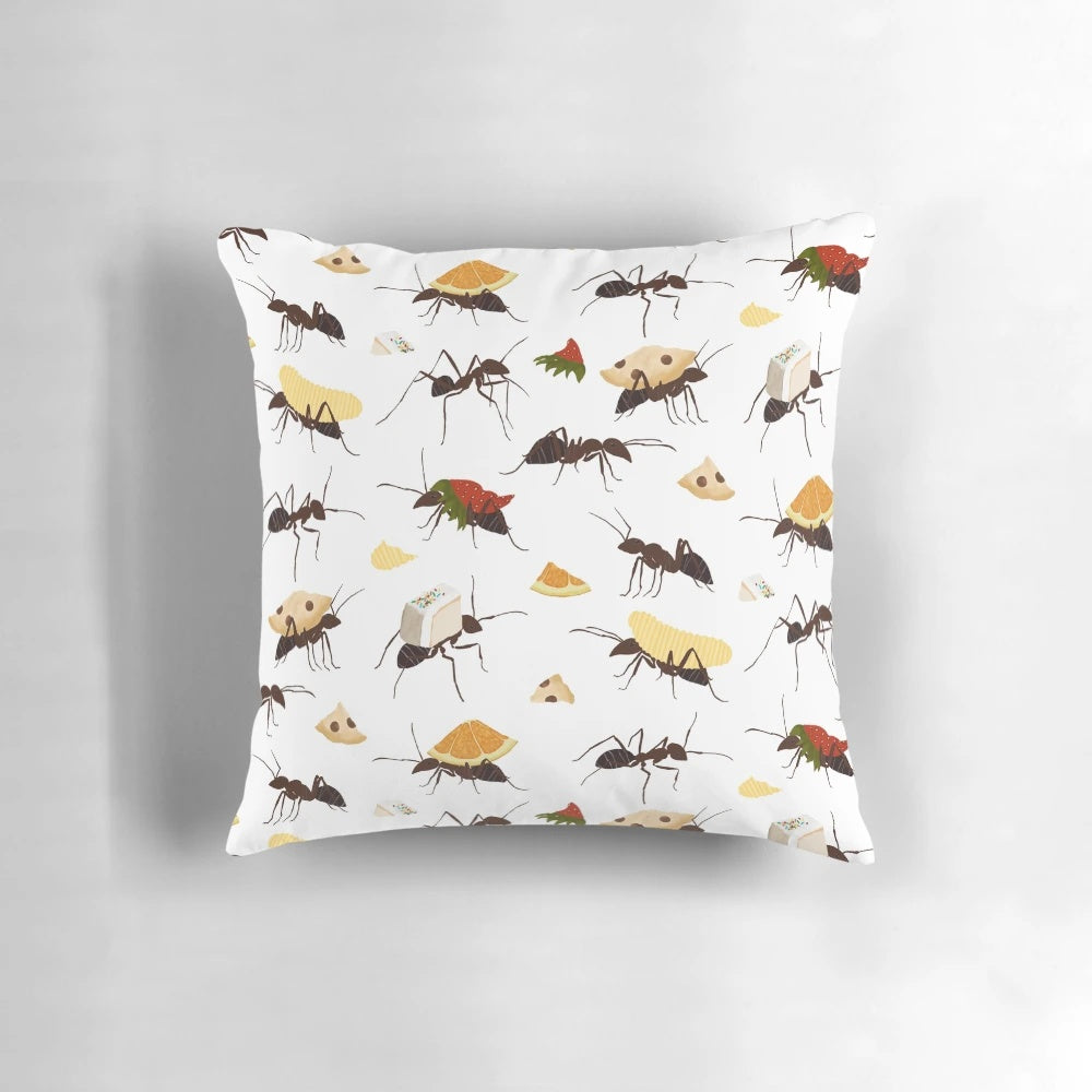 Decorative pillow featuring cute illustration of ants carrying various snacks
