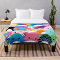 Colorful plush blanket featuring a family of cute axolotl creatures