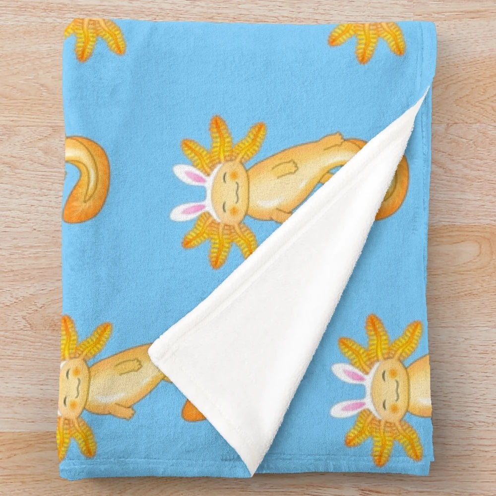 Cozy axolotl plush blanket with kawaii pattern and golden accents