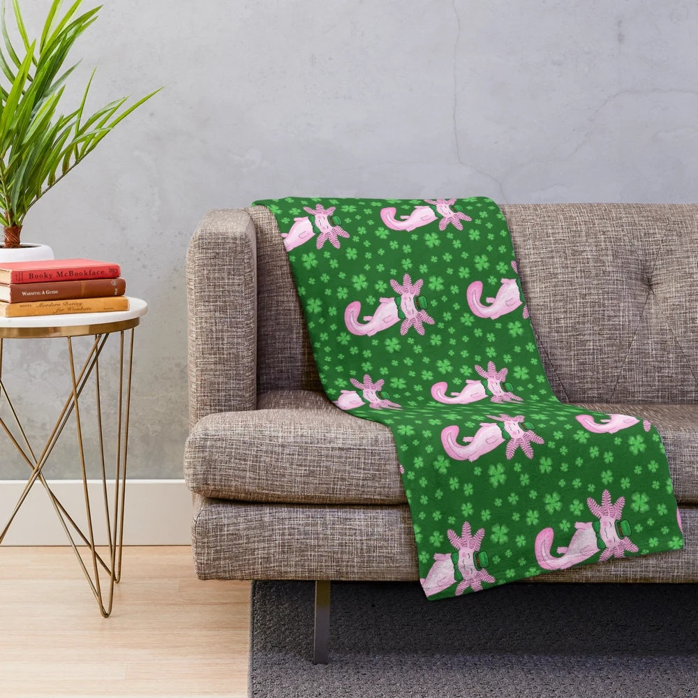 Cozy green and white plush blanket featuring an adorable axolotl design and clover pattern