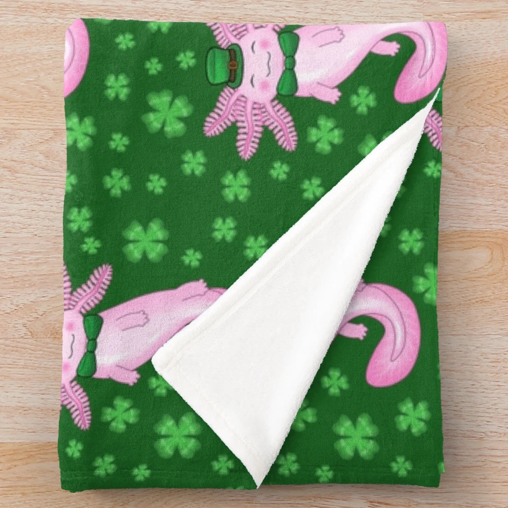 Cozy green and white plush blanket featuring an adorable axolotl design and clover pattern