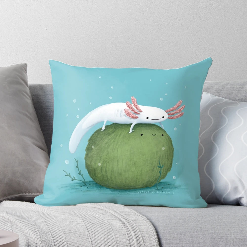 Photograph of a cute, leucistic axolotl sitting on a green, moss-covered ball-shaped pillow
