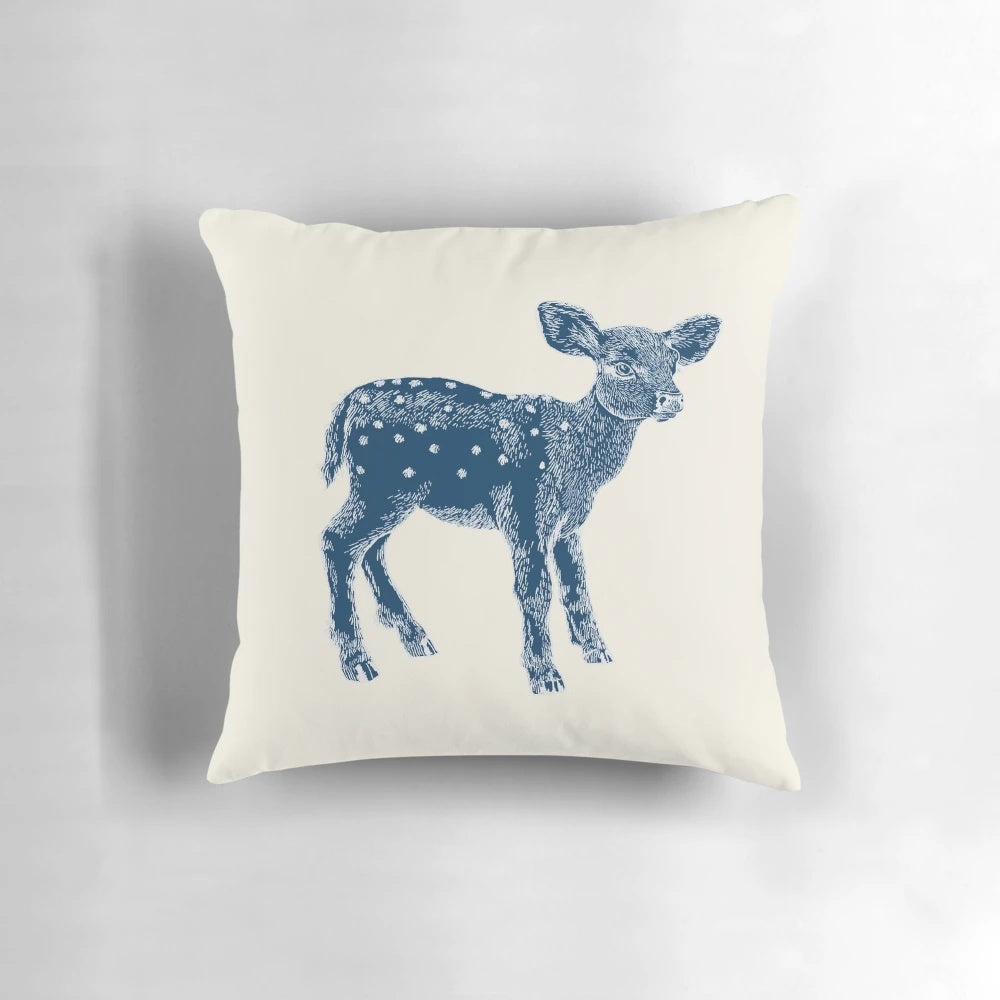 Decorative indigo and cream pillow featuring a cute baby deer illustration