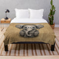 Cute baby elephant wearing headphones and glasses on a soft, cozy plush blanket