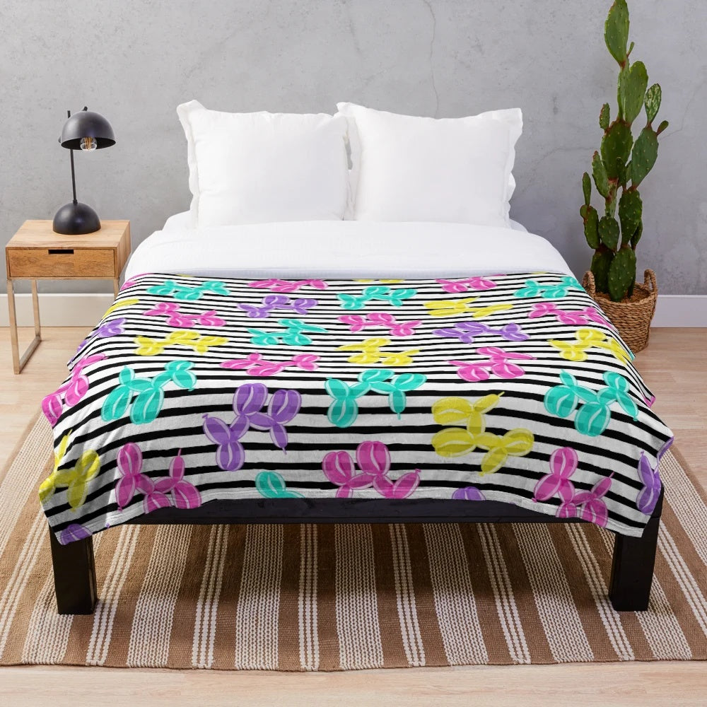 Colorful balloon dog plush blanket with black and white striped pattern