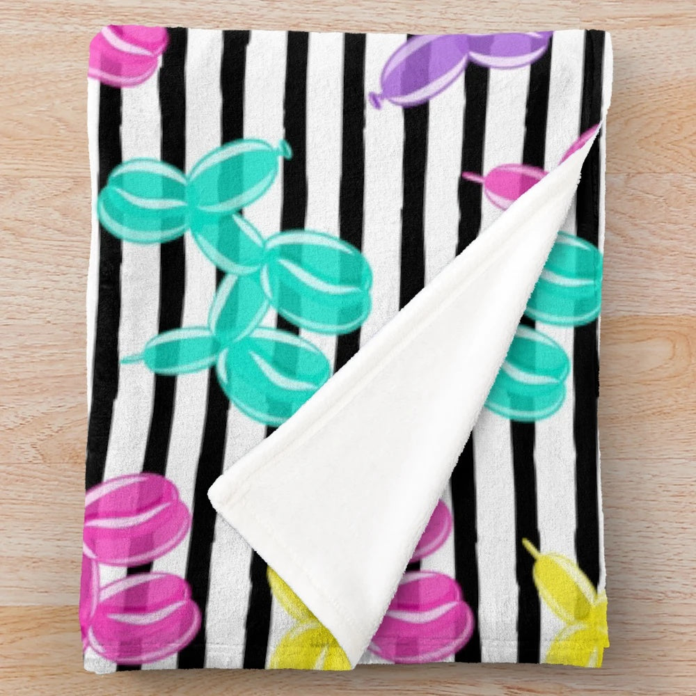 Colorful balloon dog plush blanket with black and white striped pattern