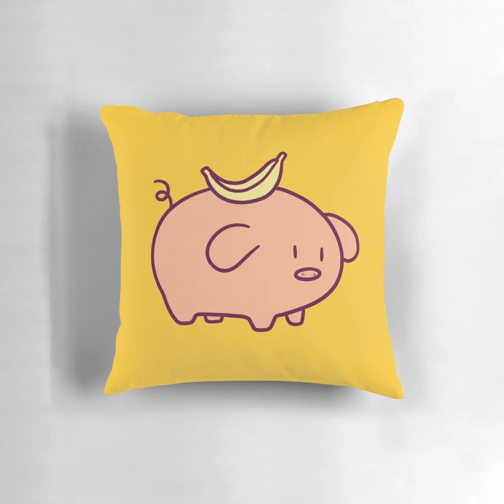 Closeup of a soft, plush pillow in the shape of a cute, chibi-style banana-colored pig.