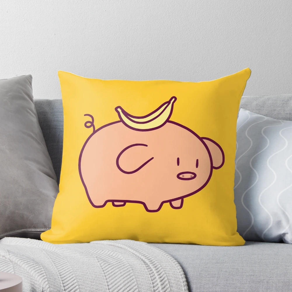 Closeup of a soft, plush pillow in the shape of a cute, chibi-style banana-colored pig.