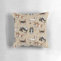 Pair of Basset Hound puppies cuddling on a tan pillow