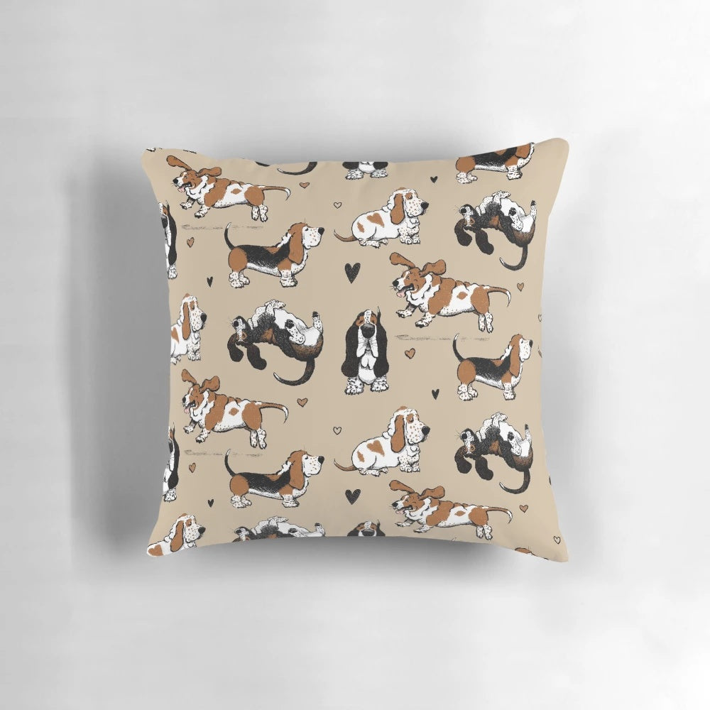 Pair of Basset Hound puppies cuddling on a tan pillow
