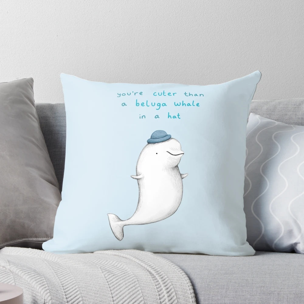 A soft, plush pillow featuring the adorable face of a beluga whale.