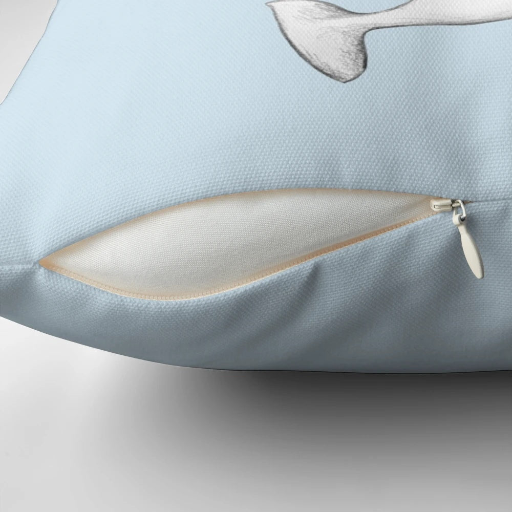 A soft, plush pillow featuring the adorable face of a beluga whale.