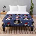 Cute Bernese Mountain Dog wearing a Santa hat on a cozy plush blanket