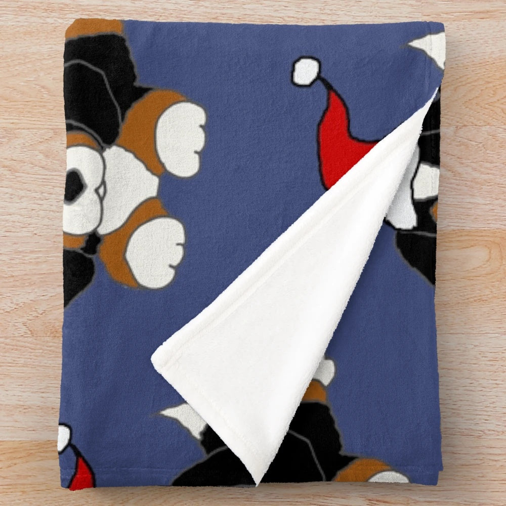 Cute Bernese Mountain Dog wearing a Santa hat on a cozy plush blanket