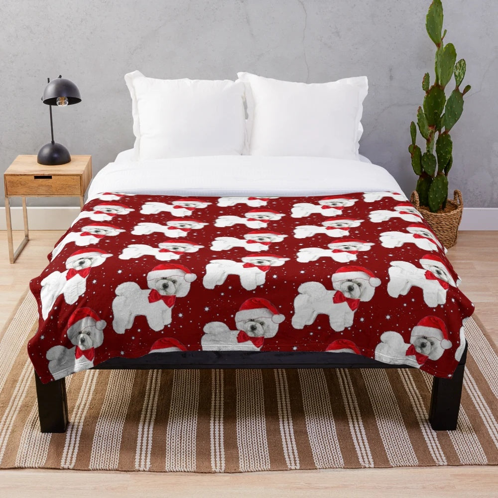 Bichon frise dog wearing a Santa hat on a cozy plush blanket