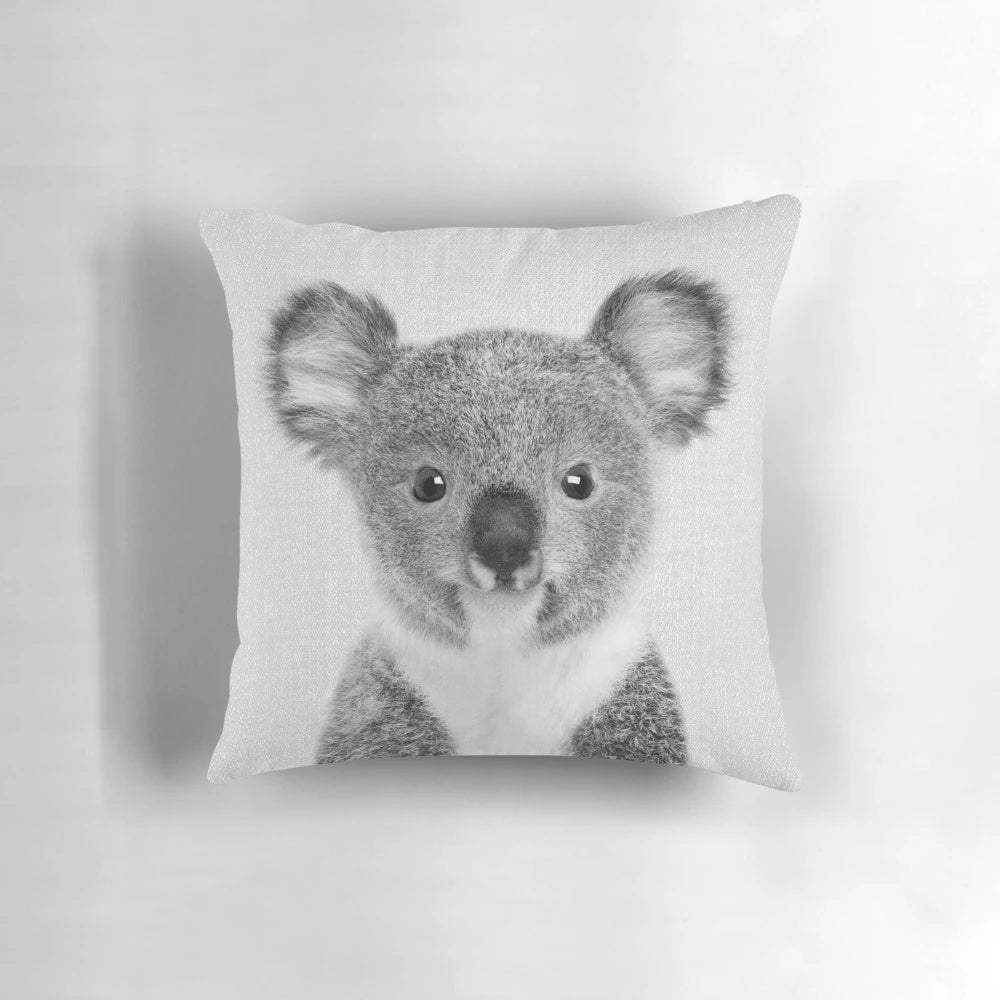 A black and white decorative pillow featuring a cute baby koala portrait, perfect for a minimalist or Scandinavian-inspired nursery.