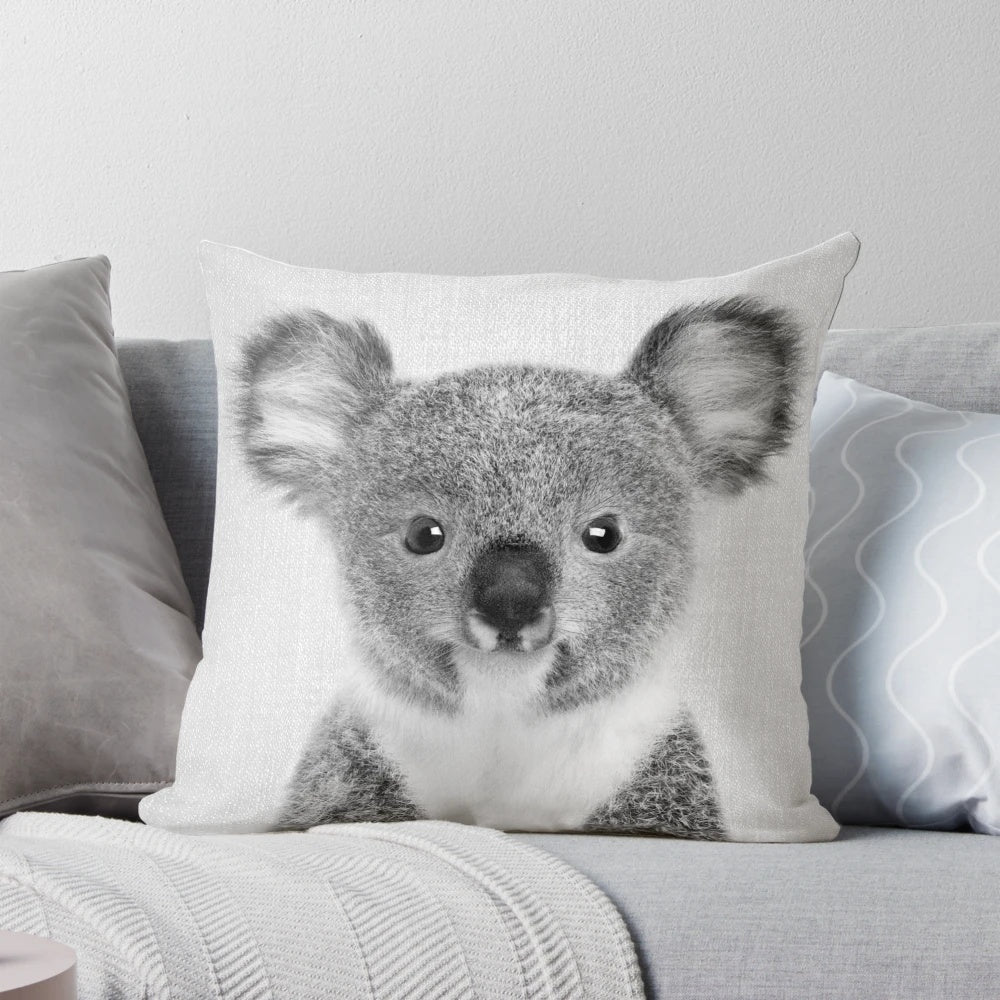 A black and white decorative pillow featuring a cute baby koala portrait, perfect for a minimalist or Scandinavian-inspired nursery.