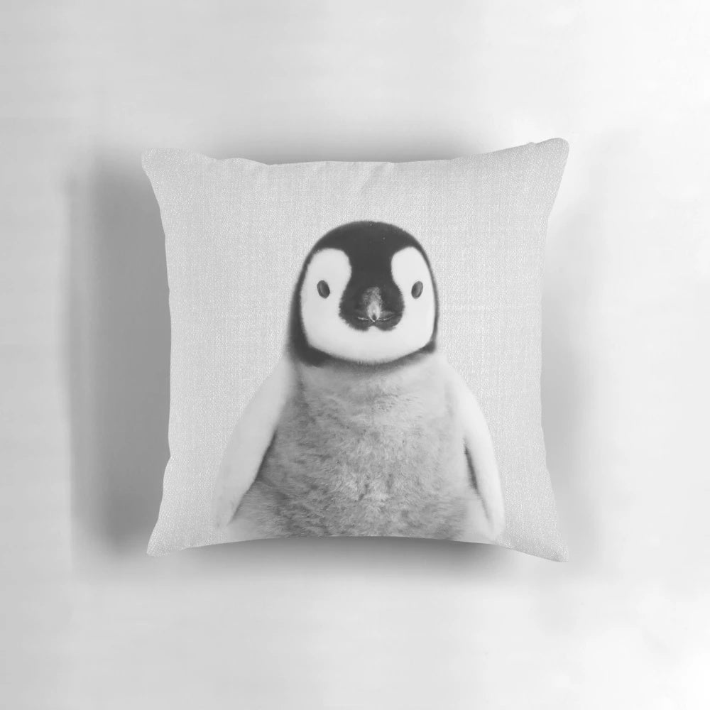 Monochrome photograph of a baby penguin on a decorative black and white throw pillow