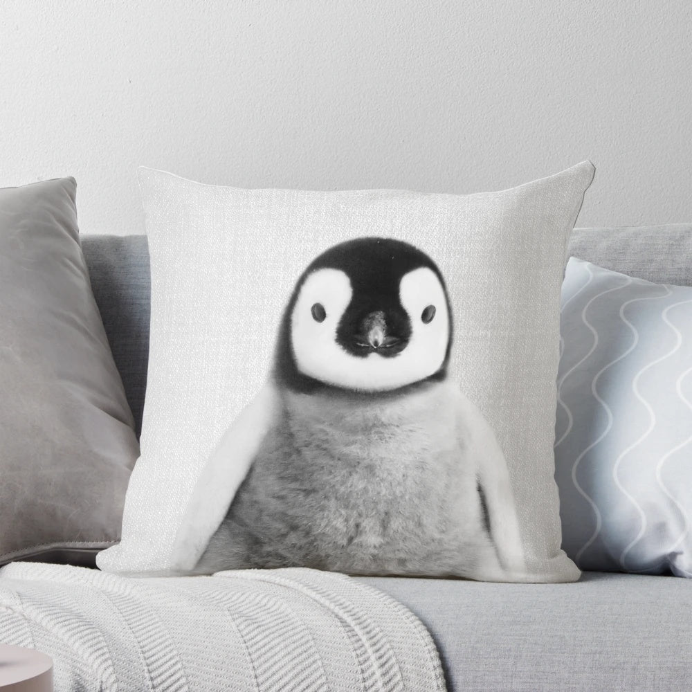 Monochrome photograph of a baby penguin on a decorative black and white throw pillow