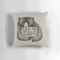 A soft, plush black and white bear pillow with the text "Feed Me and Tell Me I'm Pretty" printed on it.