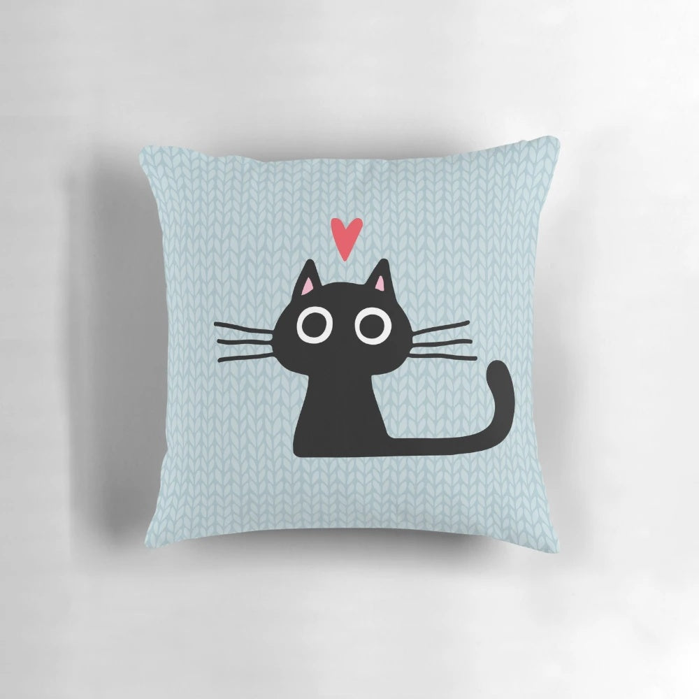Soft, heart-shaped pillow featuring an illustration of a cute black cat kitten for Valentine's Day