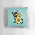 A black cat resting on a sunflower-print pillow, showcasing a charming and whimsical design